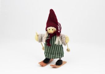 Girlie puppet on skis isolated on a white background, wood wool