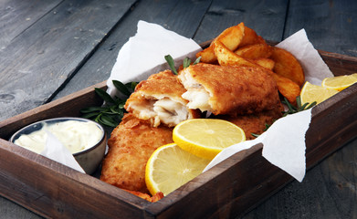 traditional British fish and chips with potato and lemon