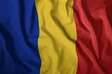 The Romanian flag is flying in the wind. Colorful, national flag of Romania. Patriotism, a patriotic symbol.