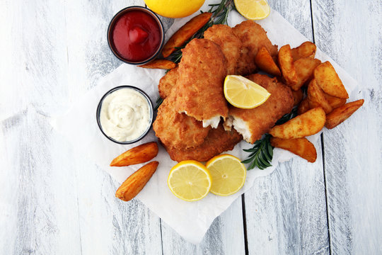 traditional British fish and chips with potato and lemon