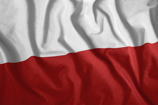The Polish flag is flying in the wind. Colorful, national flag of Poland. Patriotism, a patriotic symbol.