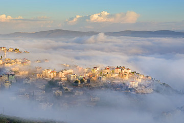 biblical village Cana of Galilee ( Kafr Kanna ) in morning fog, Nazareth in Israel - obrazy, fototapety, plakaty