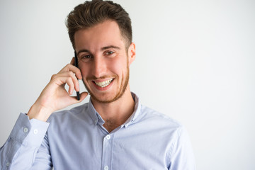 Face of cheerful businessman talking on phone