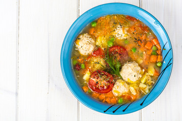 Chicken broth with vegetables and meatballs
