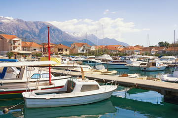 Fototapeta na wymiar Fishing boats in harbor. Marina Kalimanj in Tivat city, Montenegro