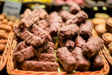 Chocolate cookies with nuts are on the display case 
