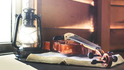 Violin with old bible book