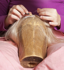 Professional Wig Maker Working in her Workshop.