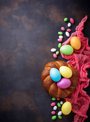 Fototapeta na wymiar Colorful Easter eggs and wicker bread 