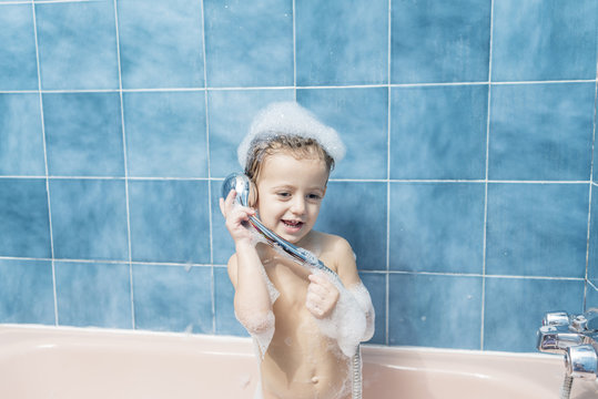 Child playing with the shower head