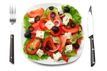 Square plate of greek salad isolated on white. fresh vegetable salad top view