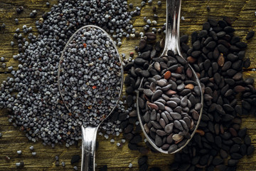 Poppy and black sesame seeds in a spoons