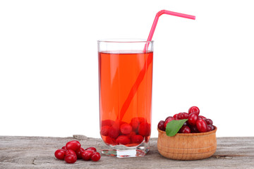 dogwood berries in wooden bowl with dogwood juice on old wooden table with white background