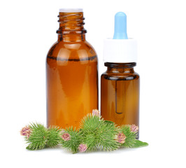 bottle with burdock (castor, agrimony) oil isolated on white background