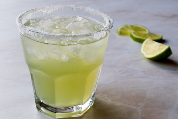 Classic Margarita Cocktail in Salted Glass with Lime and Crushed ice.