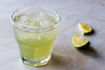 Classic Margarita Cocktail in Salted Glass with Lime and Crushed ice.