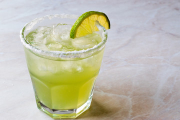 Classic Margarita Cocktail in Salted Glass with Lime and Crushed ice.
