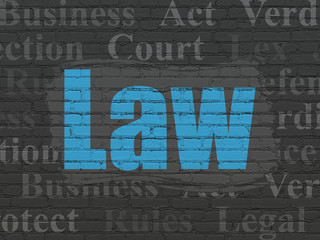 Law concept: Painted blue text Law on Black Brick wall background with  Tag Cloud