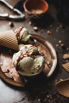 Ice cream with butterscotch sauce and hazelnuts