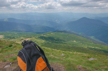 backpack in the mountains on a sunny summer day.