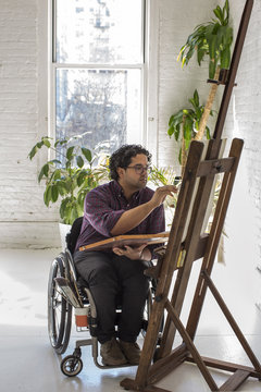 Man painting by an easel