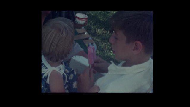 1964 Boy feeds little girl ice cream