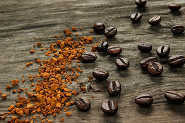 Coffee beans and instant coffee on a wooden table.