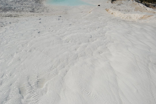Deposits of travertine in Pamukkale, Turkey. Travertine &mdash; tufa, polycrystalline fragile grained homogeneous rock, formed by the minerals calcium carbonate, lime carbonate sediment sources, hot spring