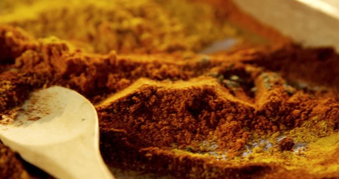 Various spices powder in wooden tray 