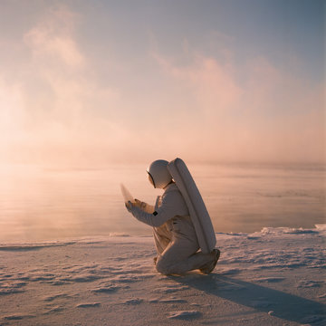 Man in astronaut costume on knees