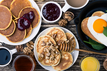 Valentine's day breakfast  with  heart shape fried egg in cast iron skillet and pancakes