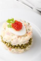 Obraz na płótnie Canvas Russian Olivier salad with red caviar on top