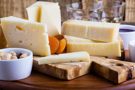 Cheese platter with fruit jam, nuts and wine