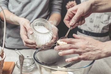 Mothers and children's hands cook dough for home-made cookies. We cook in kitchen together with children. Happy family