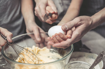 Mothers and children's hands cook dough for home-made cookies. We cook in kitchen together with children. Happy family