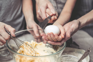 Mothers and children's hands cook dough for home-made cookies. We cook in kitchen together with children. Happy family