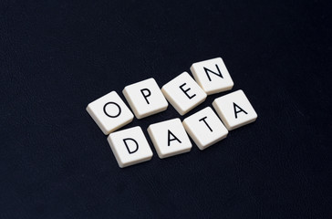 Open data text on a black leather surface. Image taken in an angle.