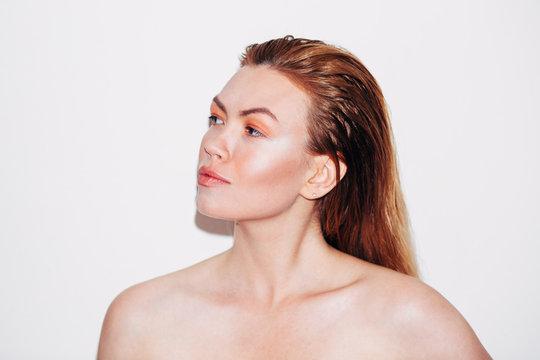 Beauty shoot, expressive ginger woman with great skin over white background