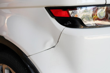 Damaged backside of the white car from the accident