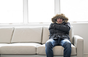 Man With Warm Clothing Feeling The Cold Inside House on the sofa