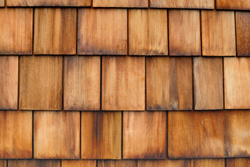 Detail of an exterior wall of wooden shingle shake siding.