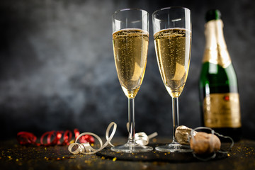 Two champagne glasses in golden glitter