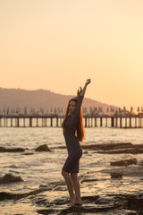 Fototapeta na wymiar Beautiful female enjoying sunset by the beach