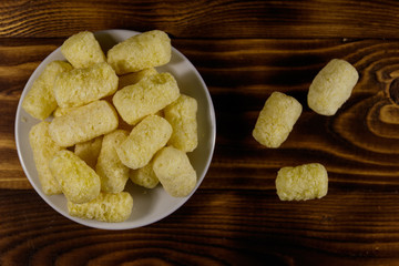 Sweet corn sticks on a plate on wooden table