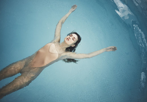 Woman Floating at Swimming Pool