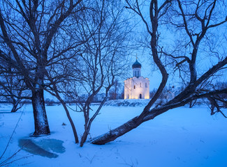 Ancient Russian Church of the Intercession on the Nerl with illumination in the winter twilight