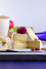 Cheese, camembert, honey, purple bottle, Greek roll with cottage cheese, apples, cheese on an ultraviolet background, peanuts, pink flower, minimalism, healthy food, milk in a glass, pop art, retro st