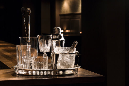 Vintage glassware and bar gear on a bar counter