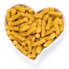 Uncooked fusilli pasta isolated white background.