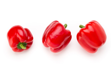 Red bell pepper with half and leaves isolated on white.